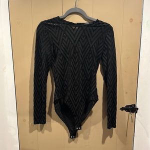 Black long sleeve mesh body suit w/ open back. Velvet design w/ sparkles.